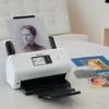 Brother ADS3350W compact desktop scanner digitizing vintage photographs with touchscreen display
