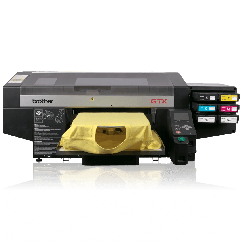 Brother GTX direct-to-garment printer printing yellow tote bags with dual platens