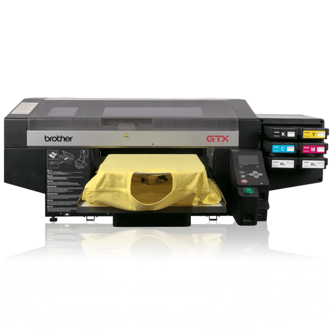 Brother GTX direct-to-garment printer printing yellow tote bags with dual platens