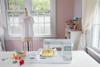 Brother Innovis NS1250E sewing and embroidery machine in bright craft room with colorful thread
