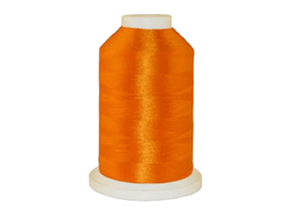 Brother orange embroidery thread spool on white background