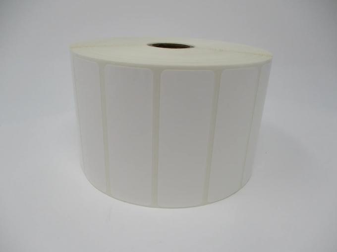 Roll of white die-cut shipping labels on cardboard core
