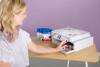 Woman installing ink cartridges in Brother sublimation printer with colorful design on top