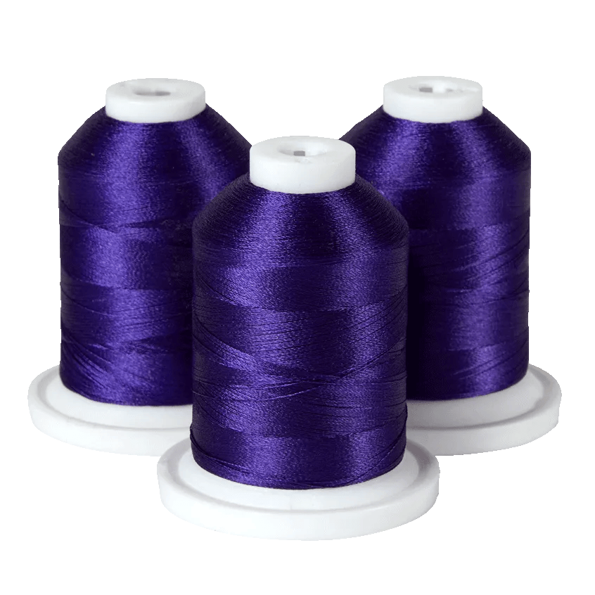 Three spools of purple embroidery thread on white bases for Brother sewing machines