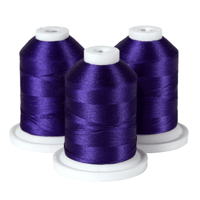 Three spools of purple embroidery thread on white bases for Brother sewing machines