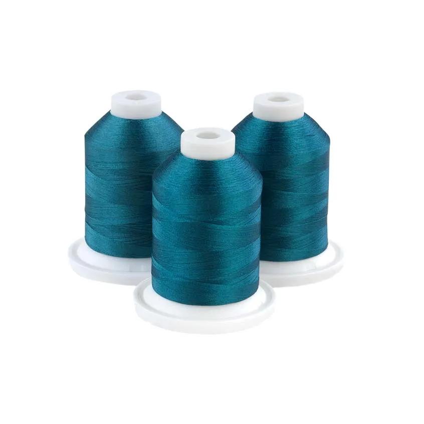 Three teal embroidery thread spools on white bases for sewing and crafting projects