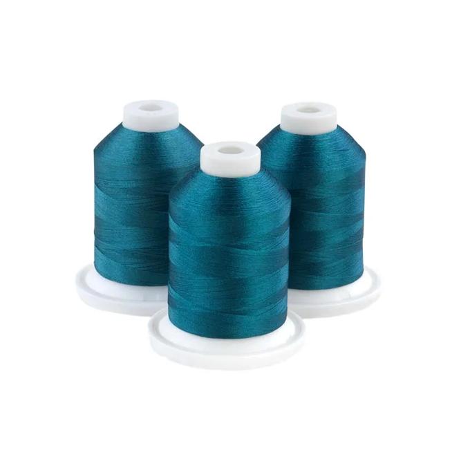 Three teal embroidery thread spools on white bases for sewing and crafting projects
