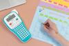 Brother PT-H103W label maker next to hand writing on colorful desk calendar