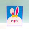 Handmade Easter bunny card with embossed blue background and yellow polka dot bow tie