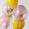 Brother SDX125e sewing machine displayed with colorful celebration balloons and confetti