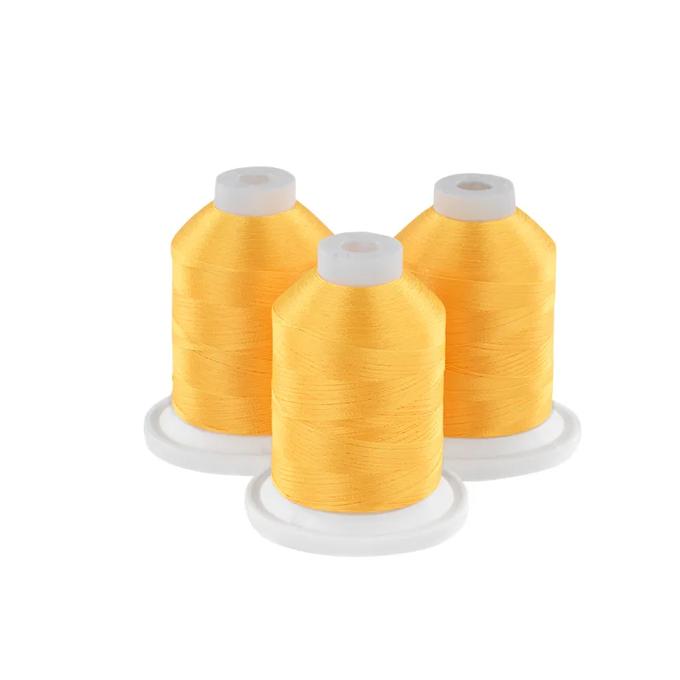 Three yellow embroidery thread spools on white bases