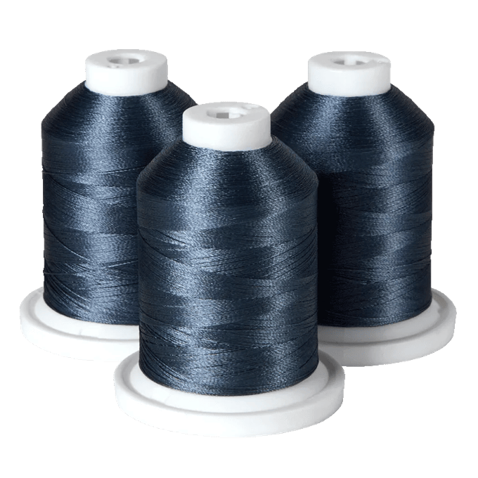 Three spools of dark blue embroidery thread on white bases