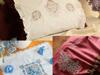 Embroidered pillowcases and fabric with decorative floral and butterfly stitching patterns