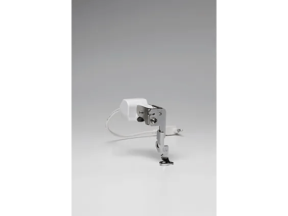 Brother sewing machine motor with clamp attachment and power cord on white background