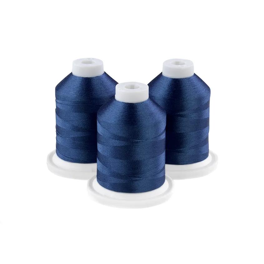 Three navy blue embroidery thread spools on white bases