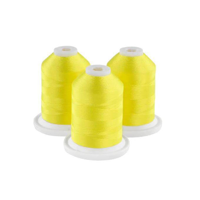 Three bright yellow embroidery thread spools on white bases