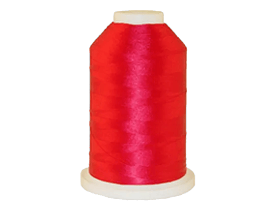 Red embroidery thread spool on white background