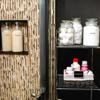Organized bathroom shelves with labeled jars for bath salts, body butter, and toiletries