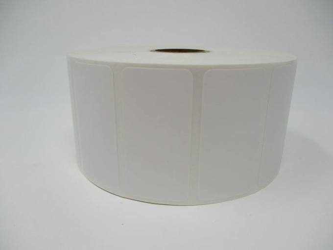 Roll of white die-cut labels with rounded corners on cardboard core
