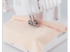 Brother serger sewing peach fabric with overlock stitch