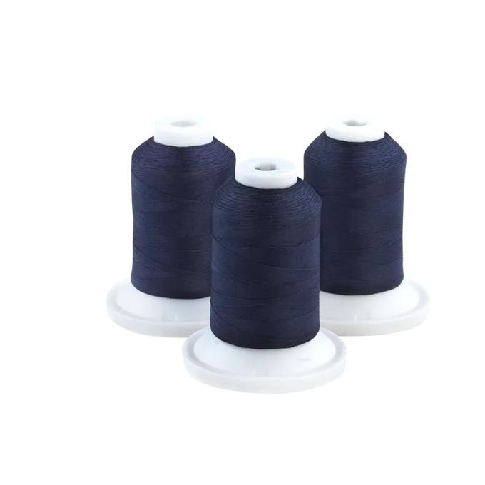 Three navy blue embroidery thread spools on white bases