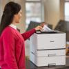Woman retrieving document from Brother HL-L8430CDWT color laser printer with dual paper trays