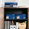 Brother TN223 4-pack toner cartridges stored in organized home office cabinet