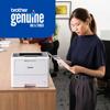 Woman reviewing document printed with Brother genuine ink and toner in modern office