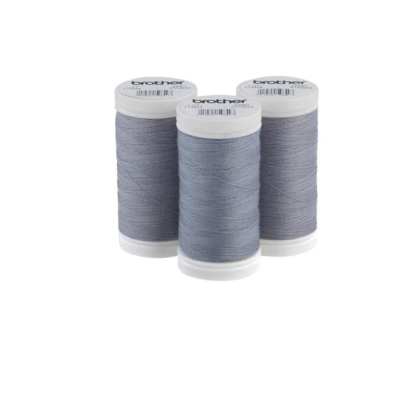 Brother grey polyester thread spools with white caps on white background