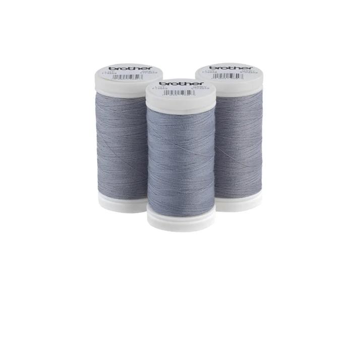 Brother grey polyester thread spools with white caps on white background