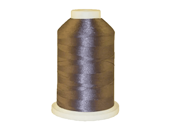 Brother embroidery thread spool in dark brown with beige cap on white base