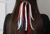 Brother customizable ribbon attached to hair with printed text and decorative patterns