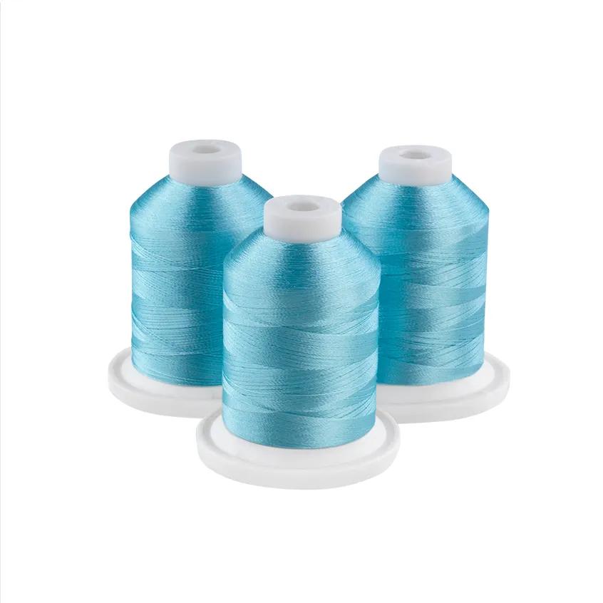 Three powder blue embroidery thread spools on white bases