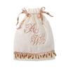 Ivory drawstring gift bag with gold monogram embroidery and beaded trim