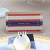 Personalized place card with decorative ribbons at outdoor dinner party table setting