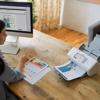Brother wireless document scanner on desk scanning business reports in home office