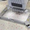 Brother embroidery machine stitching bowtie pattern on fabric in 5x7 hoop frame