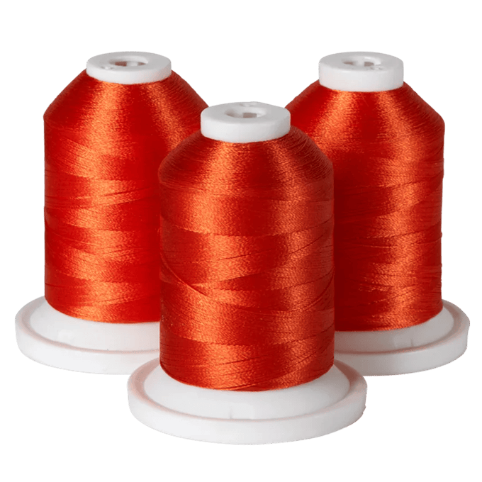 Three spools of red embroidery thread on white bases for Brother sewing machines