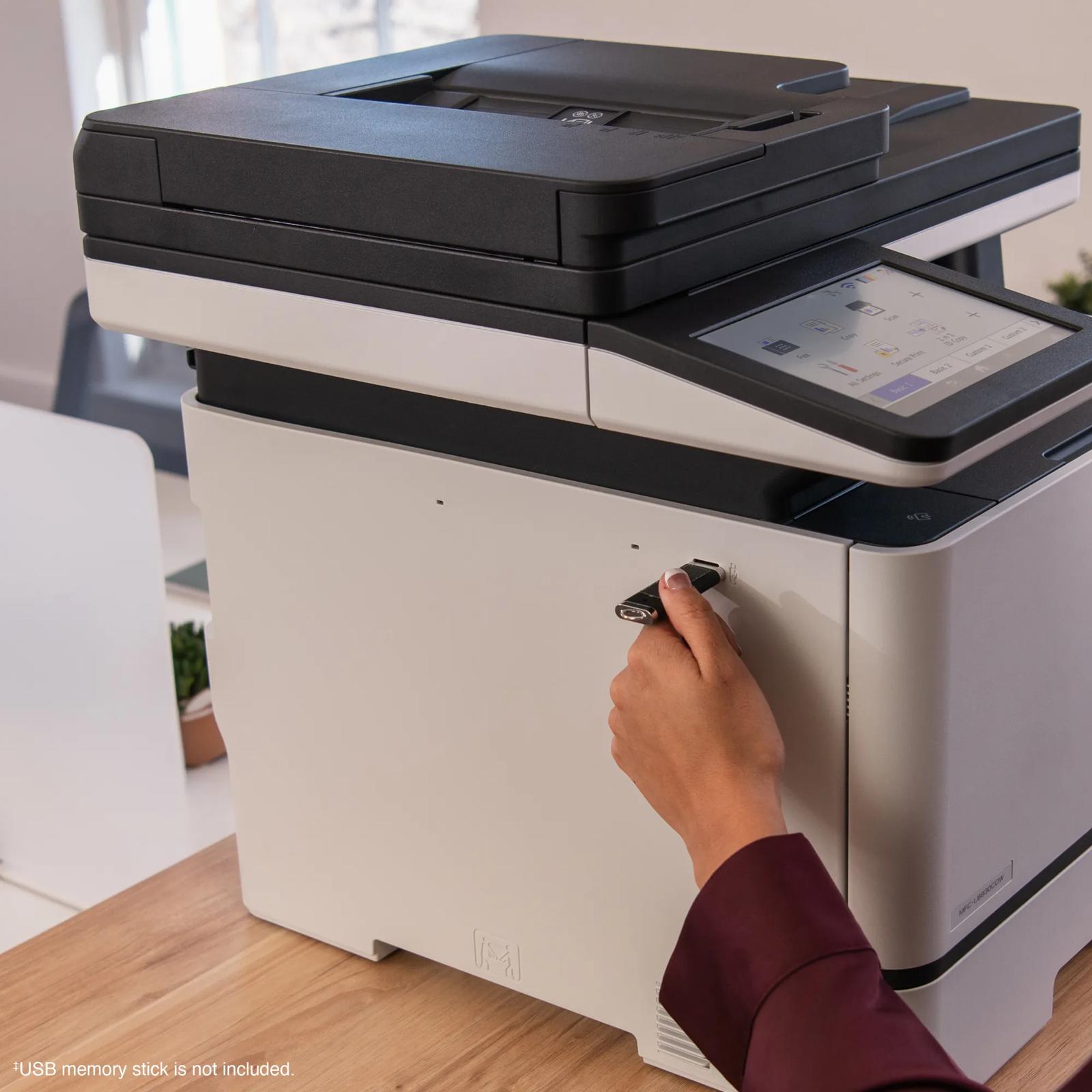 Hand inserting USB drive into Brother MFC-L8930CDW all-in-one color laser printer with touchscreen