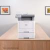 Brother MFC-L5715DW monochrome laser all-in-one printer with optional paper tray on desk
