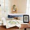 Brother embroidery machine with touchscreen displaying floral design on fabric
