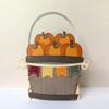 Decorative paper basket with fall pumpkins and colorful banner crafted from textured cardstock