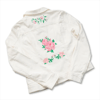 White denim jacket with pink floral embroidery created by Brother embroidery machine