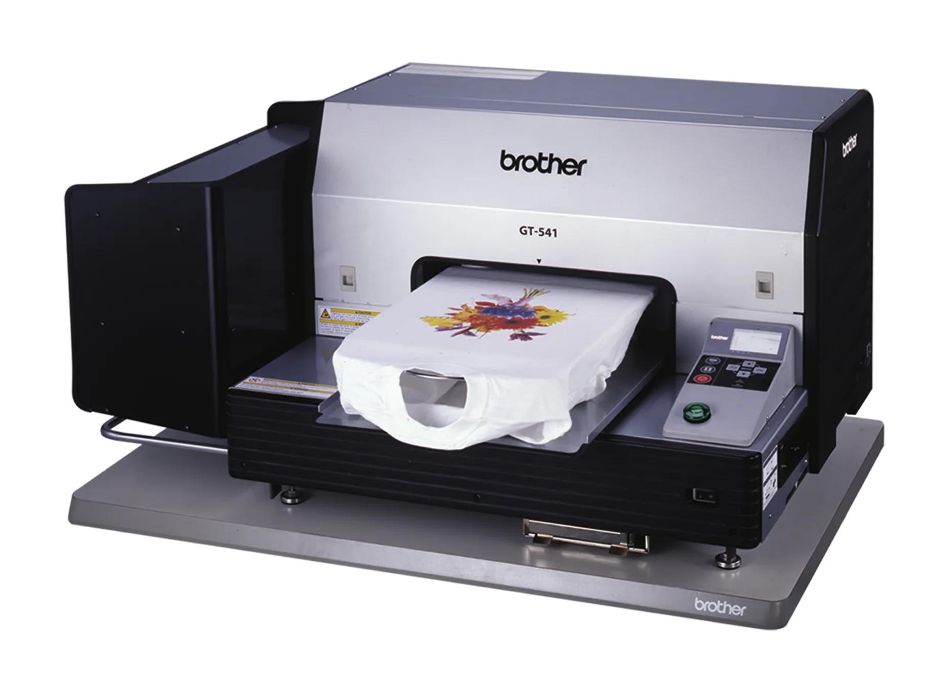 Brother GT-541 garment printer printing colorful floral design on white t-shirt