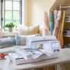 Brother embroidery machine with touchscreen on craft table in bright sewing room