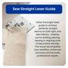 Brother sewing machine with laser guide projecting red line on beige fabric for precise stitching