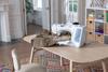 Brother sewing machine with dual-feed foot stitching fabric on home workspace table