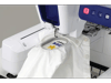 Brother embroidery machine with open hoop stitching white fabric with yellow design