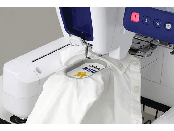Brother embroidery machine with open hoop stitching white fabric with yellow design