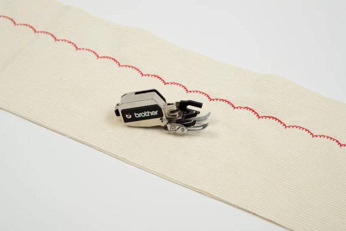 Brother dynamic walking foot creating decorative red stitch on cream fabric